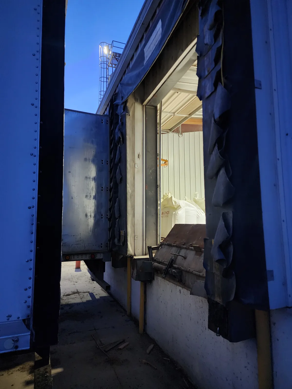 Open loading dock doorway without a closed screen or barrier